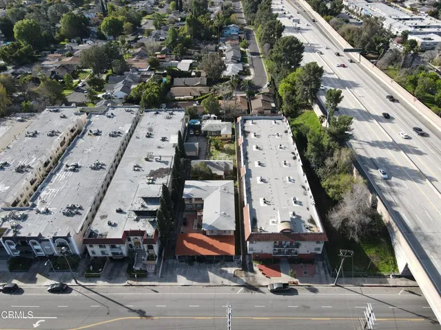 an aerial view of a building with parking