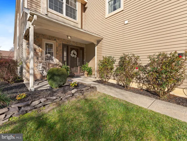 a view of a house with a small yard and plants