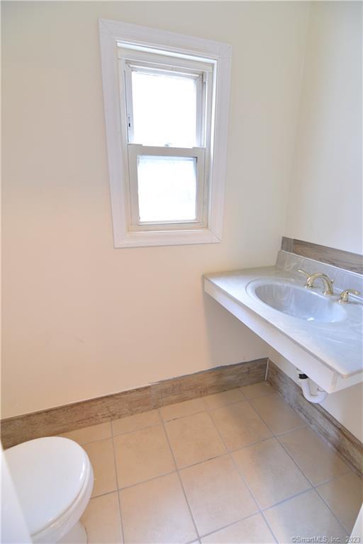 14 Wildwood Avenue Waterbury, CT 06710 - Photo 6 of 12 a bathroom with a sink a toilet and a window