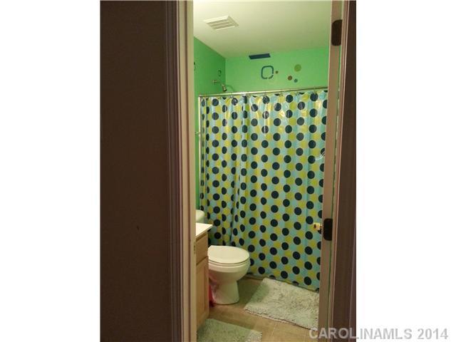 2742 Rustic Ridge Court, Unit 71 Rock Hill, SC 29730 - Photo 12 of 16 a bathroom with a toilet and a shower curtain
