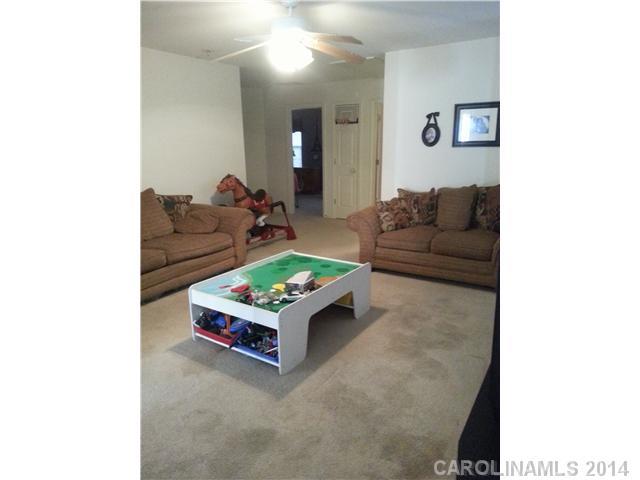 2742 Rustic Ridge Court, Unit 71 Rock Hill, SC 29730 - Photo 13 of 16 a living room with furniture and a table