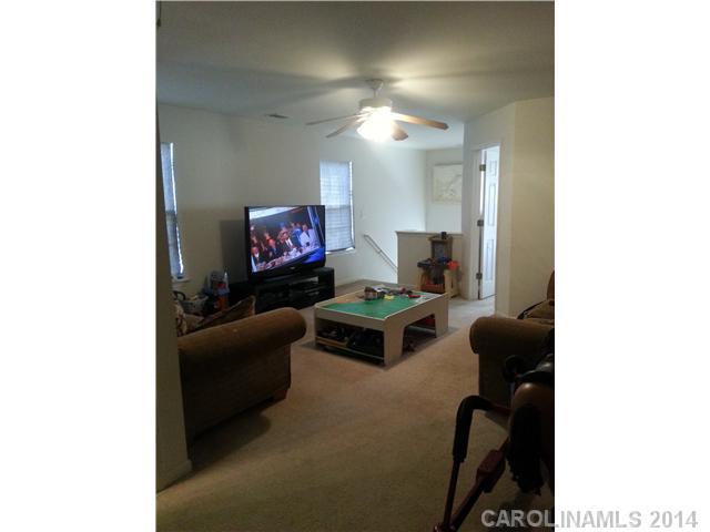 2742 Rustic Ridge Court, Unit 71 Rock Hill, SC 29730 - Photo 14 of 16 a living room with furniture and a flat screen tv