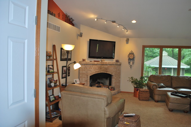 9217 Oak Ridge Drive Rochelle, IL 61068 - Photo 8 of 25 a living room with furniture a flat screen tv and a fireplace