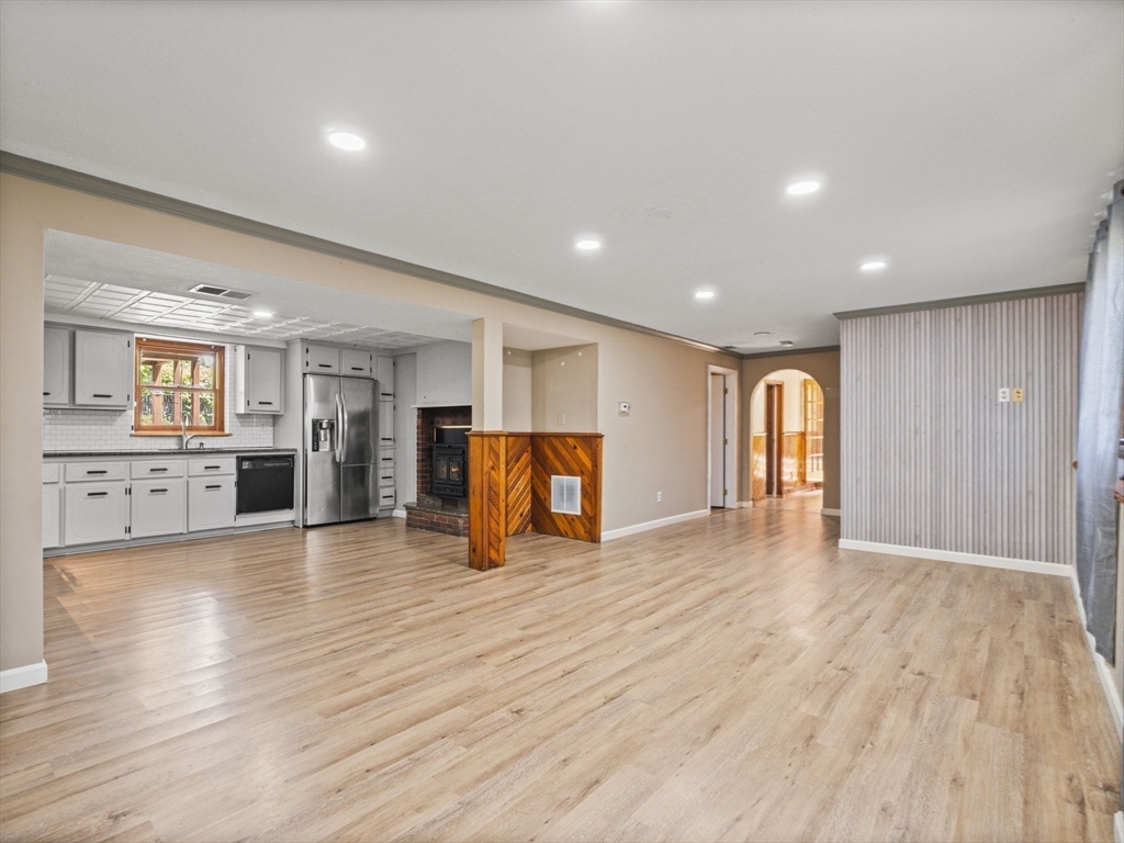 146 Lisbon Street Fall River, MA 02721 - Photo 18 of 42 a view of a livingroom with wooden floor and kitchen space with a sink