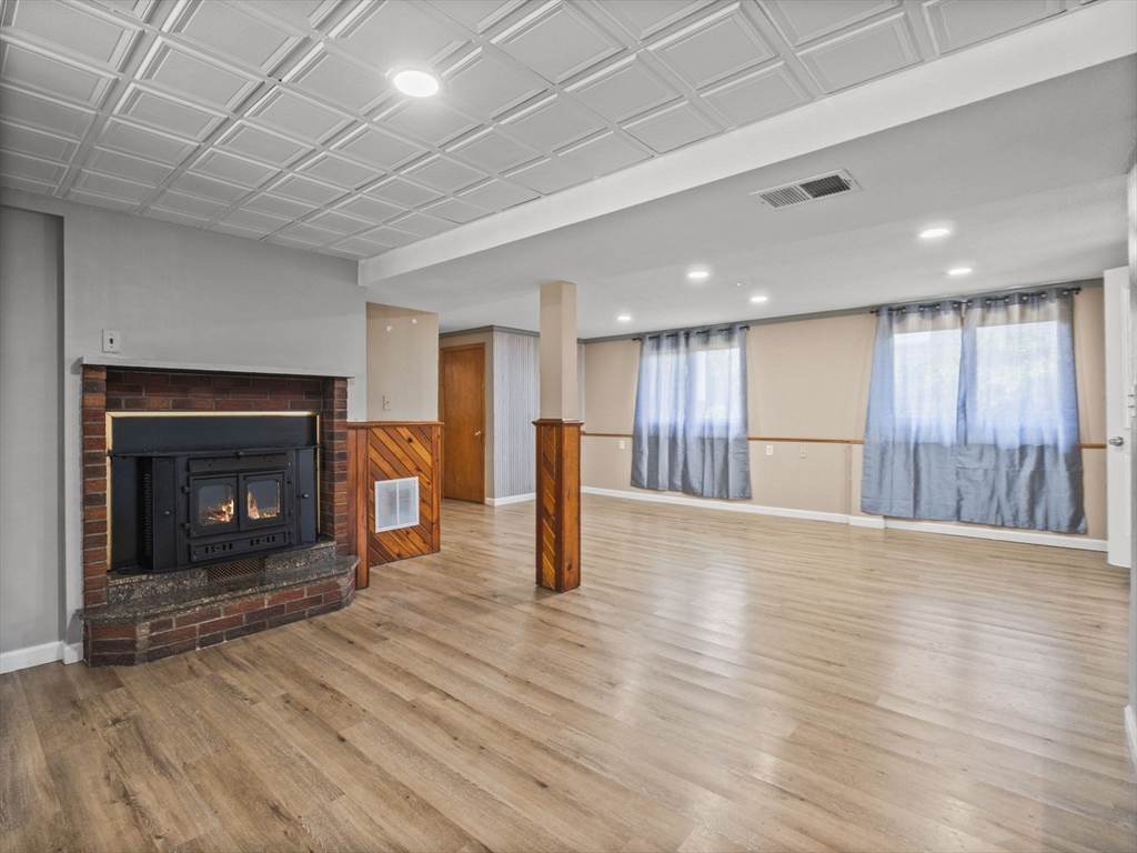 146 Lisbon Street Fall River, MA 02721 - Photo 20 of 42 a view of a livingroom with wooden floor and a fireplace