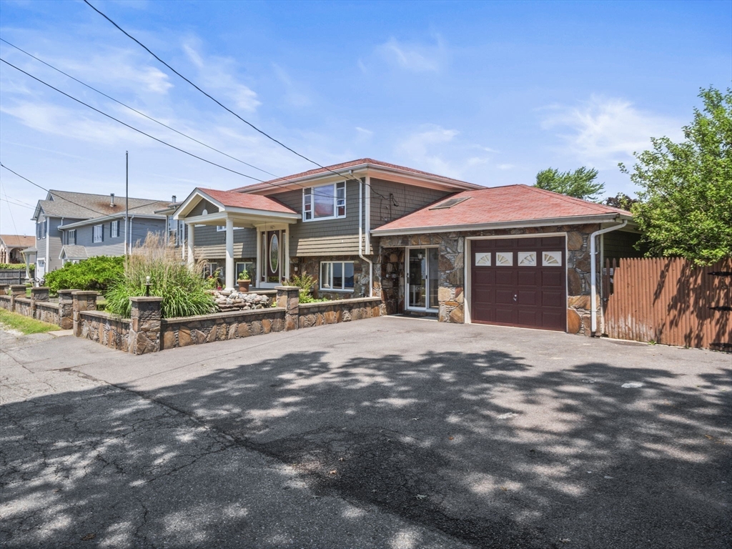 146 Lisbon Street Fall River, MA 02721 - Photo 2 of 42 a front view of a house with a garden