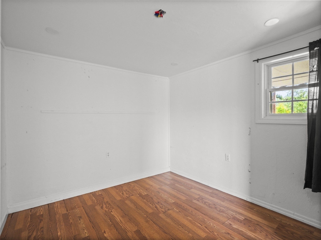 146 Lisbon Street Fall River, MA 02721 - Photo 30 of 42 an empty room with wooden floor and windows