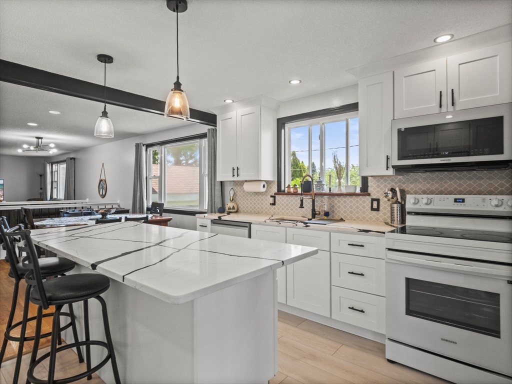 146 Lisbon Street Fall River, MA 02721 - Photo 5 of 42 a kitchen with lots of counter top space a sink appliances and cabinets