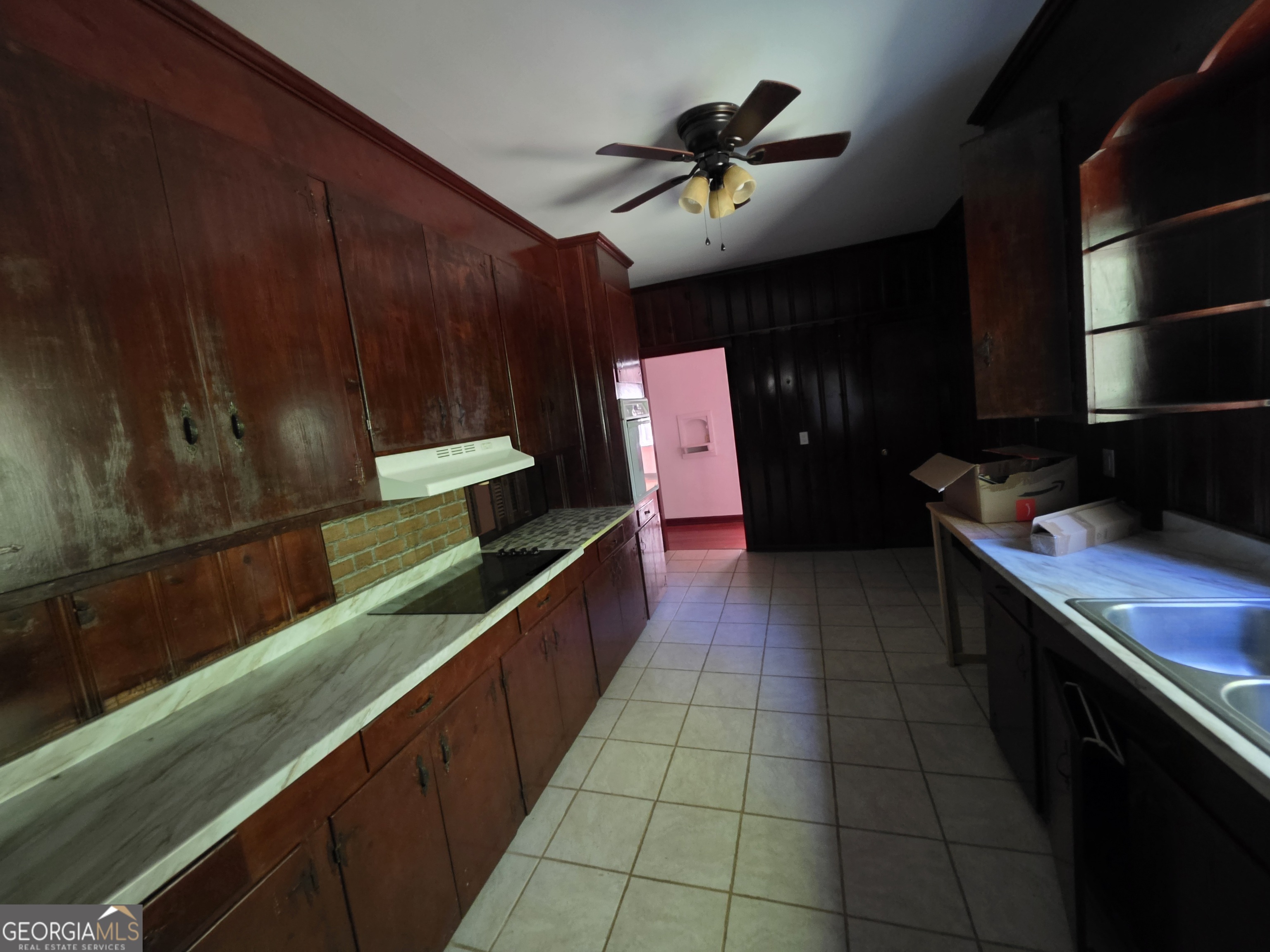 109 Springdale Drive Washington, GA 30673 - Photo 15 of 35 a kitchen with kitchen island granite countertop a stove a sink and a cabinets