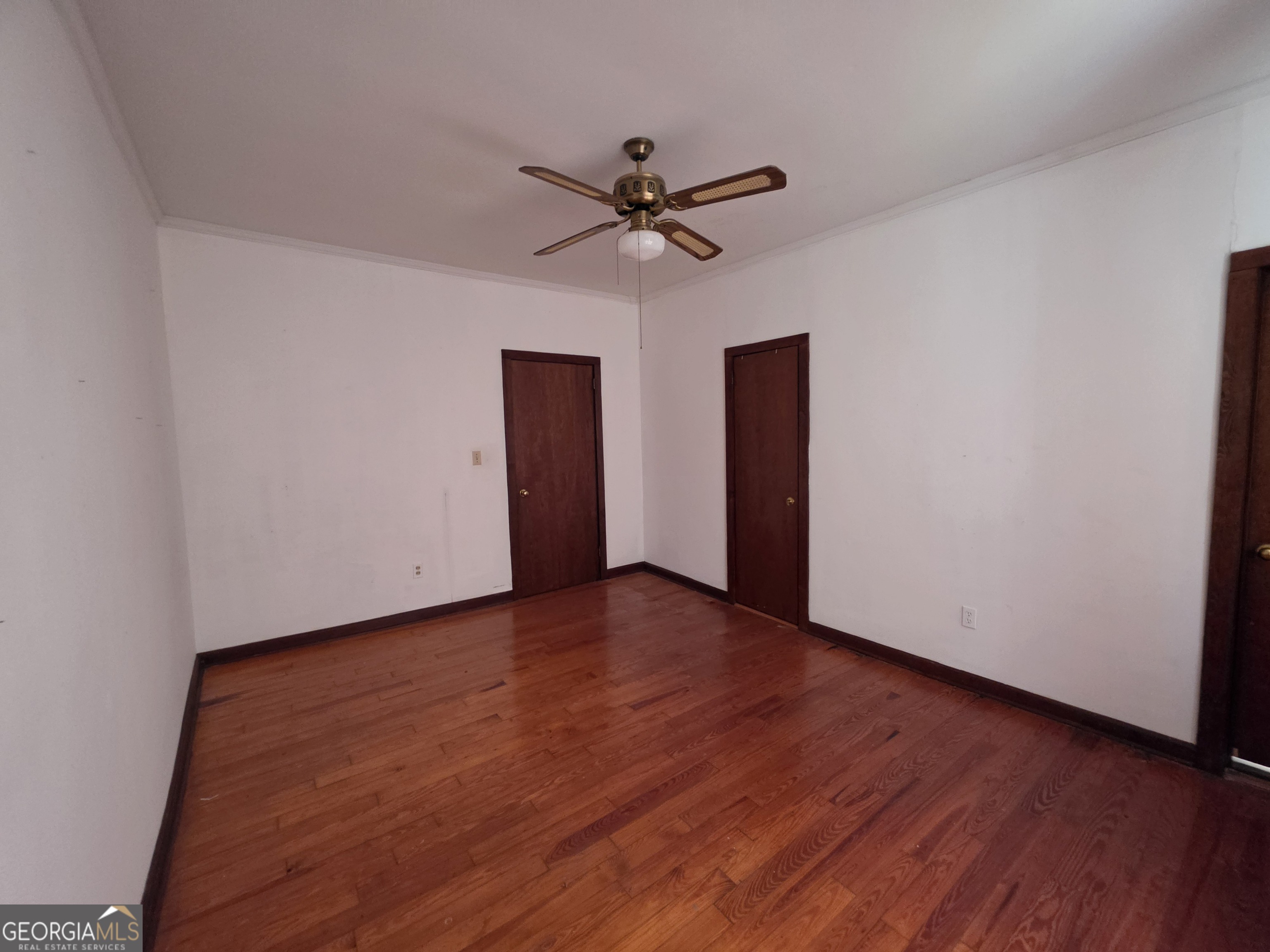 109 Springdale Drive Washington, GA 30673 - Photo 23 of 35 a view of a livingroom with a ceiling fan and wooden floor