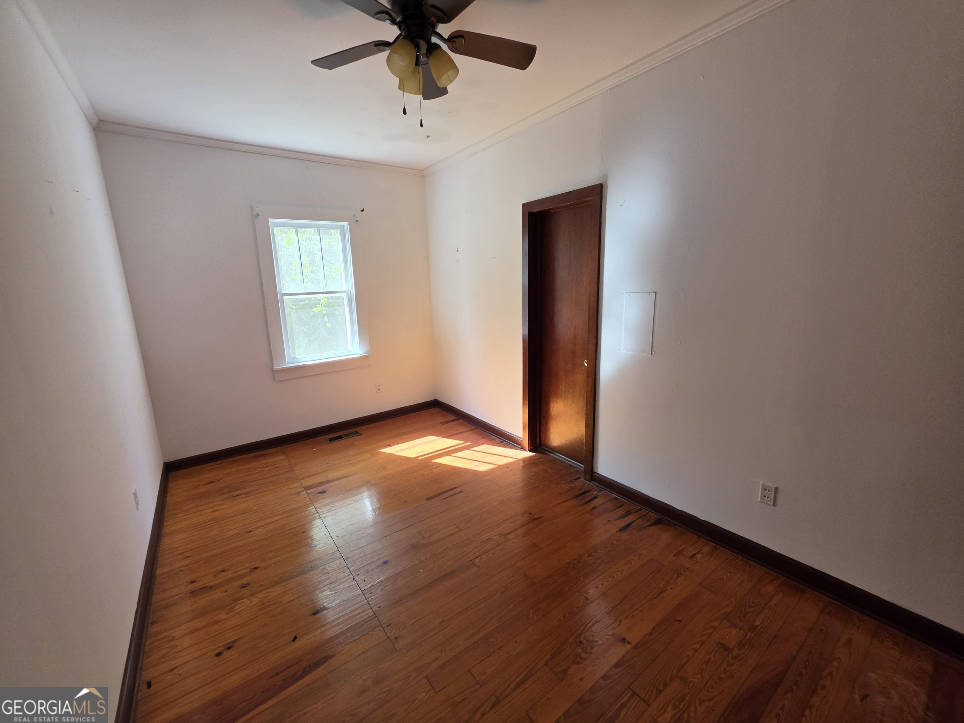 109 Springdale Drive Washington, GA 30673 - Photo 24 of 35 an empty room with wooden floor and windows
