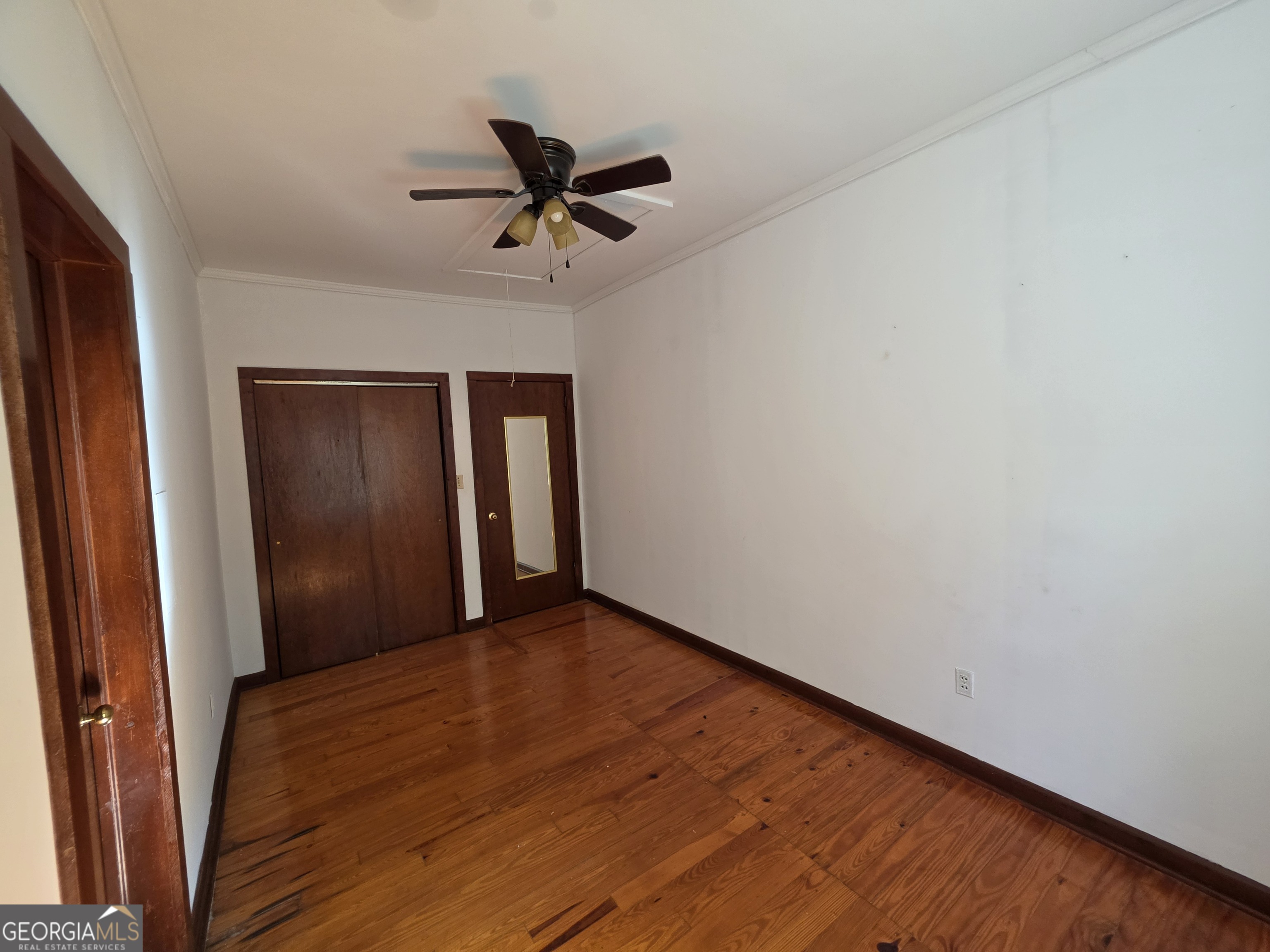 109 Springdale Drive Washington, GA 30673 - Photo 25 of 35 a view of empty room with wooden floor and fan