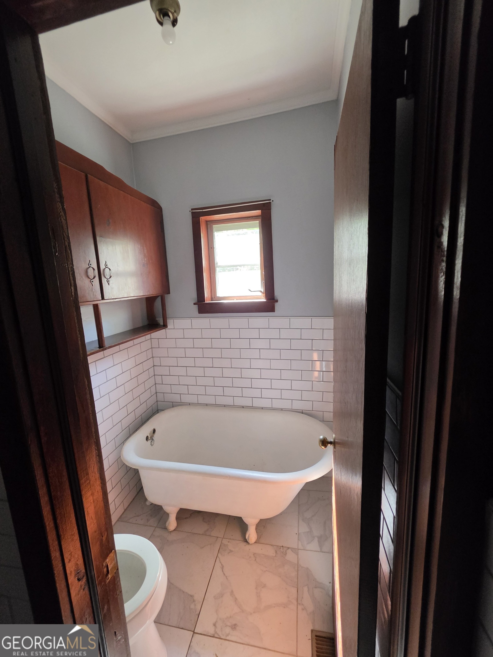 109 Springdale Drive Washington, GA 30673 - Photo 26 of 35 a bath tub sitting in a bathroom next to a small bathroom