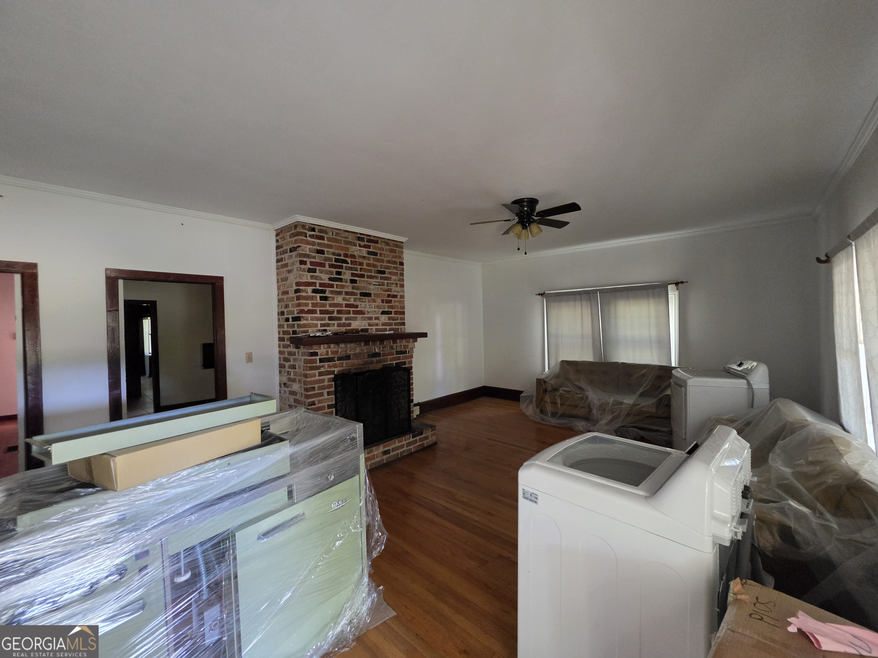 109 Springdale Drive Washington, GA 30673 - Photo 7 of 35 a living room with furniture and a fireplace