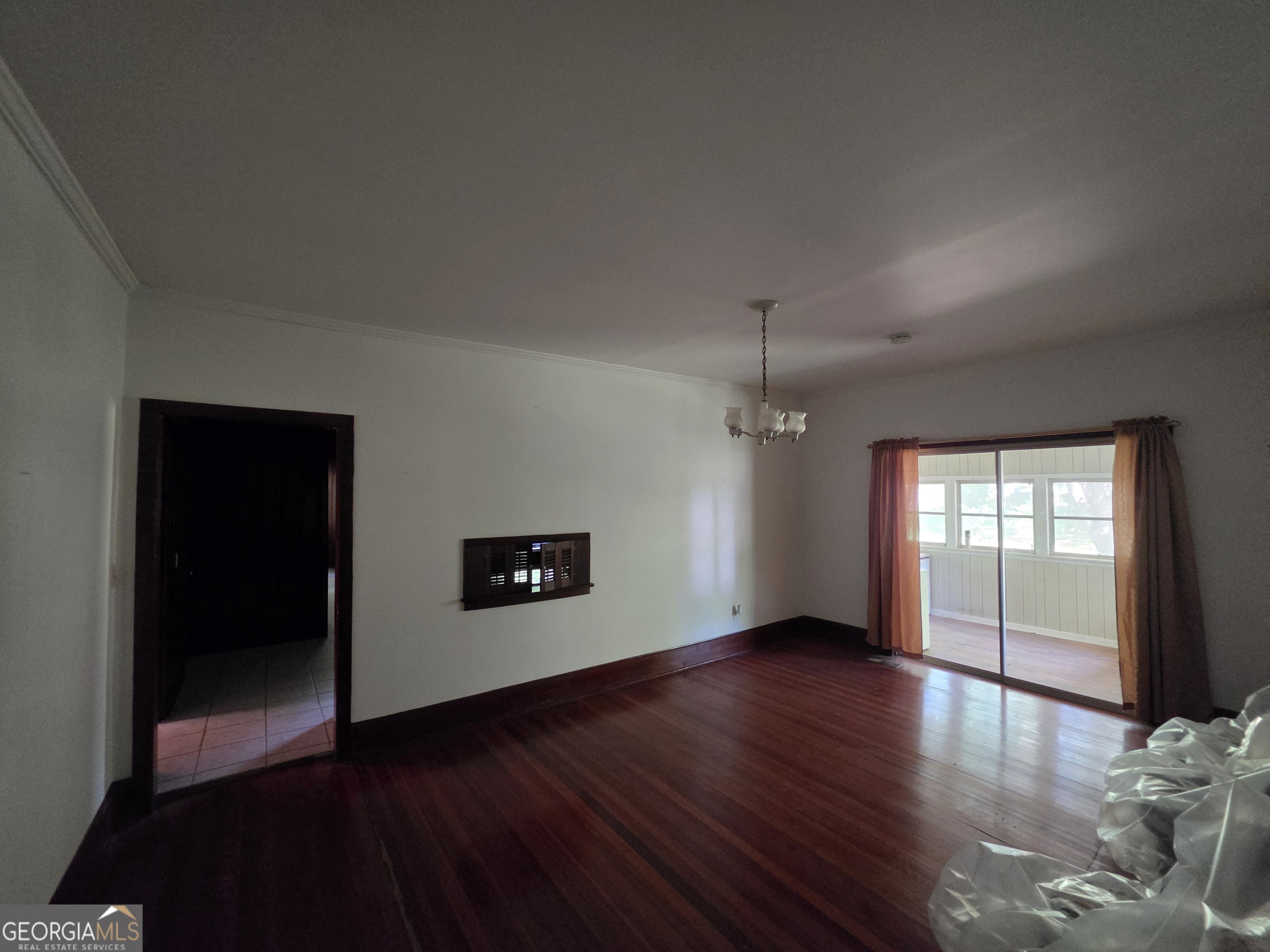 109 Springdale Drive Washington, GA 30673 - Photo 10 of 35 a view of an empty room with window and wooden floor