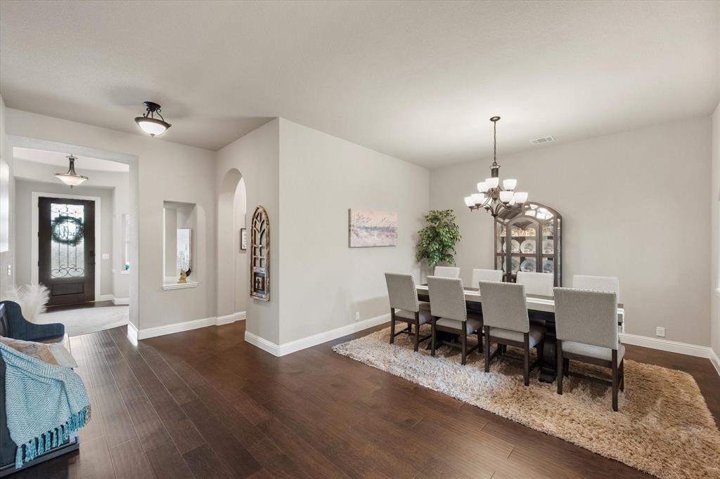 445 Rusty Run Drive Midlothian, TX 76065 - Photo 9 of 40 a view of a dining room with furniture and wooden floor