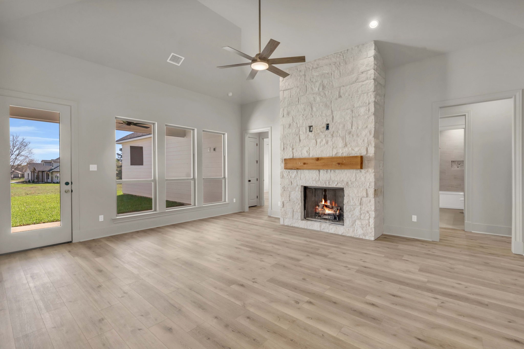 24972 Hopeview Way Montgomery, TX 77356 - Photo 5 of 38 The stone fireplace warms the area and the natural light brightens the living room.