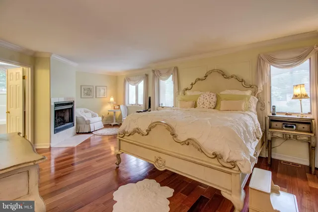 a spacious bedroom with a bed a couch and dresser