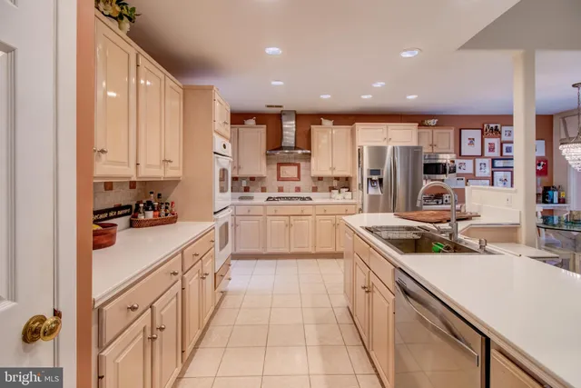 a kitchen with stainless steel appliances kitchen island granite countertop a sink and cabinets