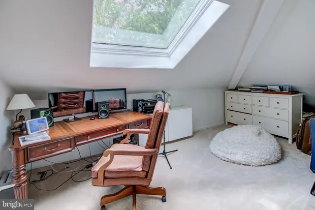 a room with furniture a air conditioner vent and a window