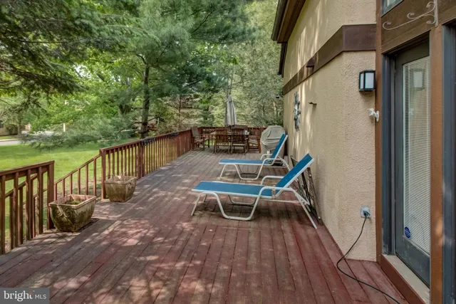 a view of a chairs and table on the balcony