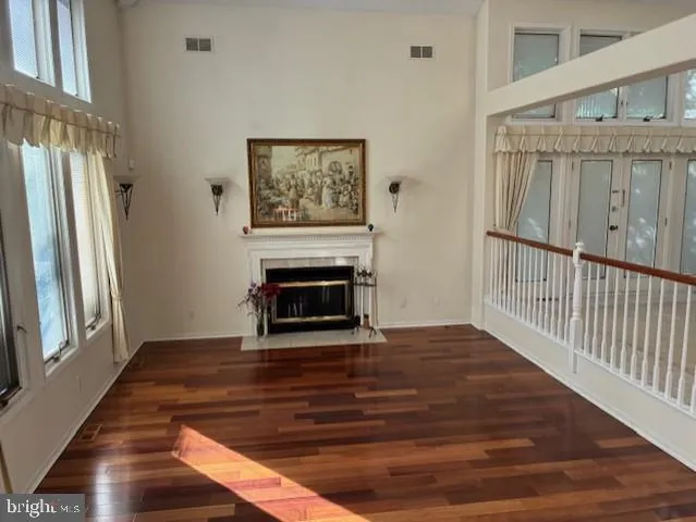 a view of a livingroom with wooden floor and a fireplace