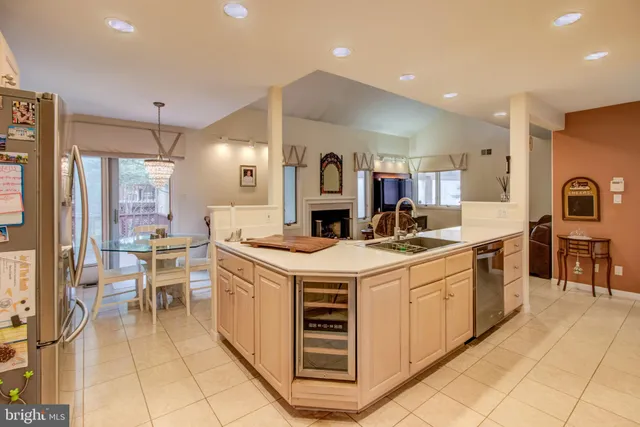 a kitchen with a sink and chairs