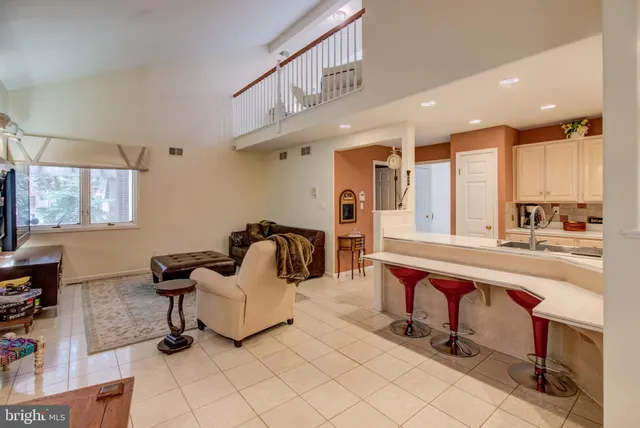 a living room with furniture a dining table and a stove top oven