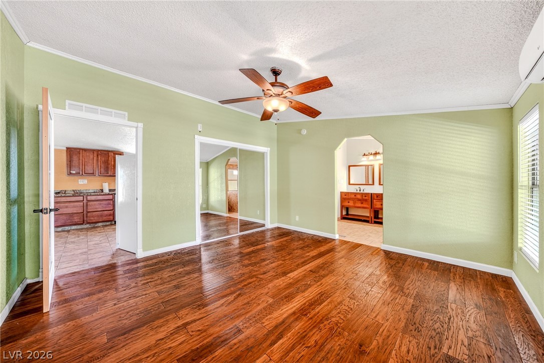 1831 West Horn Road Pahrump, NV 89048 - Photo 12 of 59 Lustrous hardwood floors extend throughout this flexible space, offering seamless transitions and a polished feel.