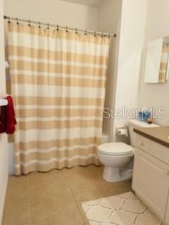 2040 Willow Hammock Circle, Unit 202 Punta Gorda, FL 33983 - Photo 12 of 21 a bathroom with a toilet and a shower curtain