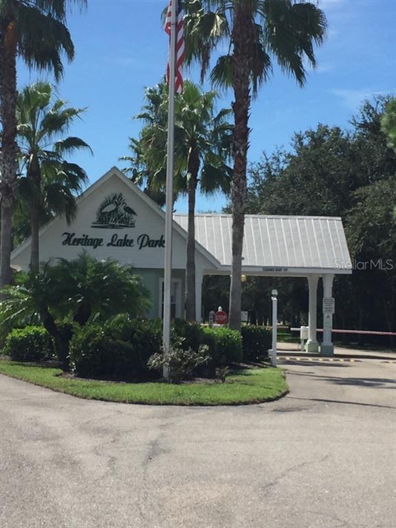 2040 Willow Hammock Circle, Unit 202 Punta Gorda, FL 33983 - Photo 17 of 21 a front view of a house with garden and trees