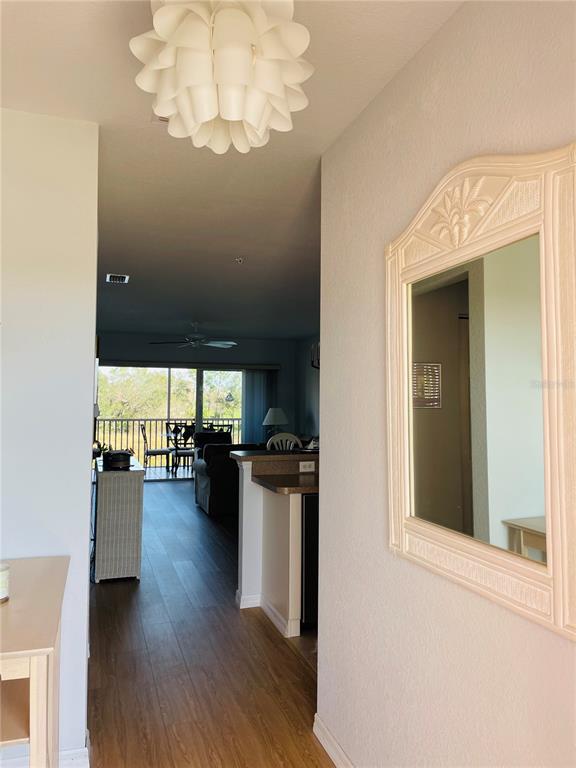 2040 Willow Hammock Circle, Unit 202 Punta Gorda, FL 33983 - Photo 2 of 21 a view of a living room and kitchen with wooden floor