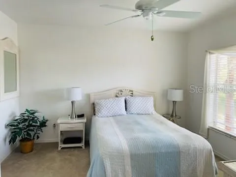 a bedroom with a bed and a potted plant
