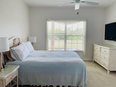 2040 Willow Hammock Circle, Unit 202 Punta Gorda, FL 33983 - Photo 8 of 21 a bedroom with a bed and a flat screen tv