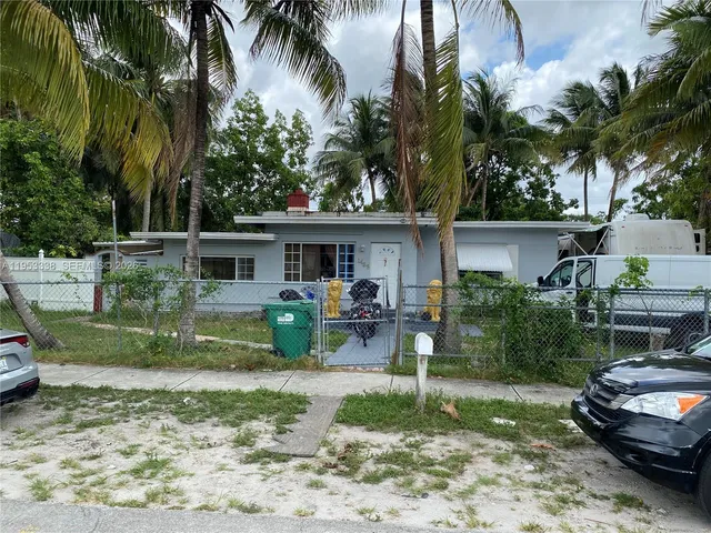 a front view of a house with garden and patio