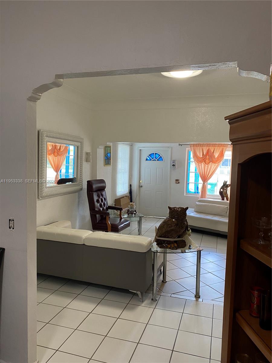 1455 Northwest 112th Street Miami, FL 33167 - Photo 12 of 19 a living room with furniture and a flat screen tv