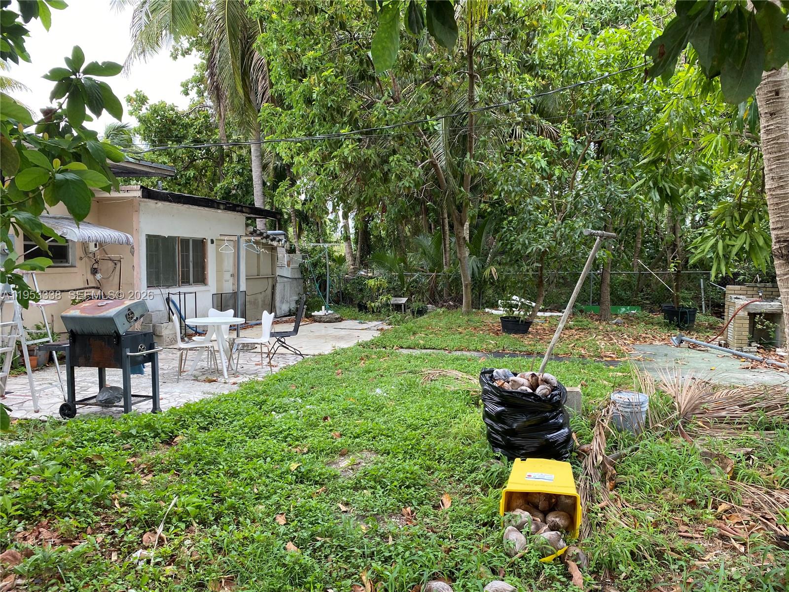 1455 Northwest 112th Street Miami, FL 33167 - Photo 19 of 19 a backyard of a house with table and chairs