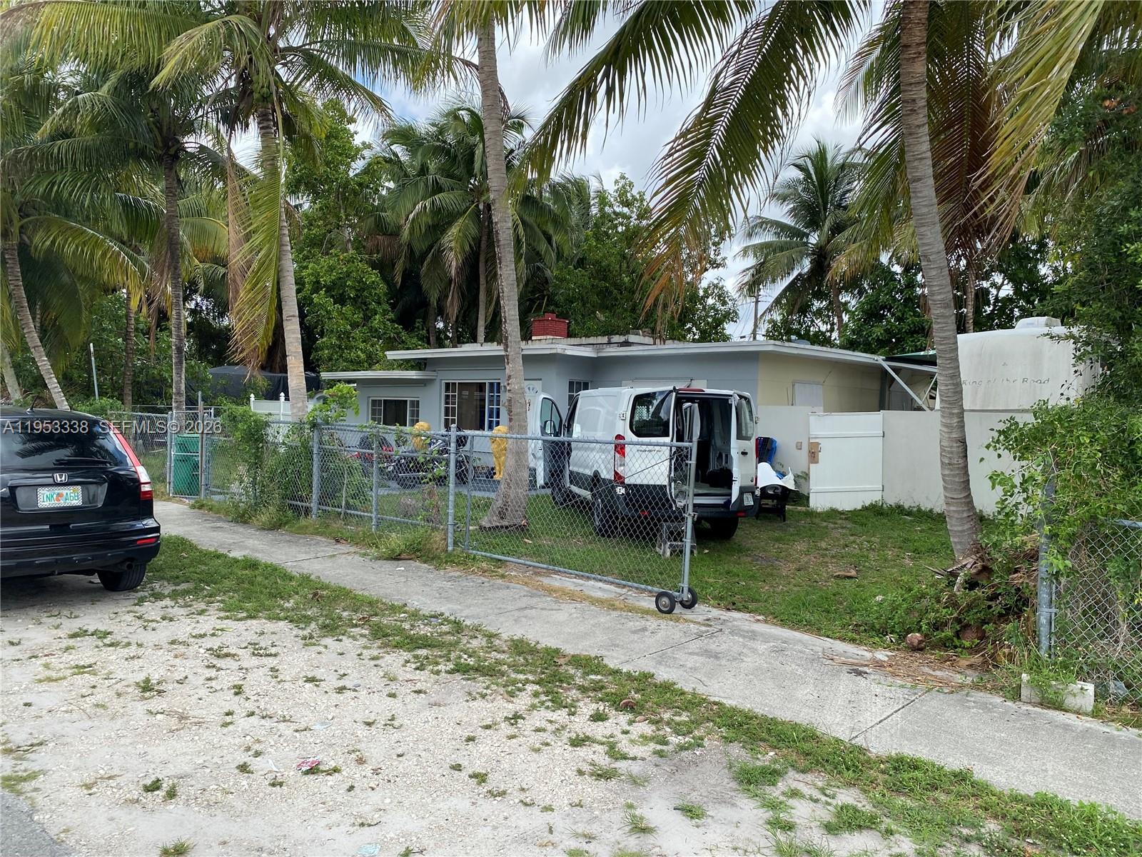 1455 Northwest 112th Street Miami, FL 33167 - Photo 2 of 19 a front view of a house with garden