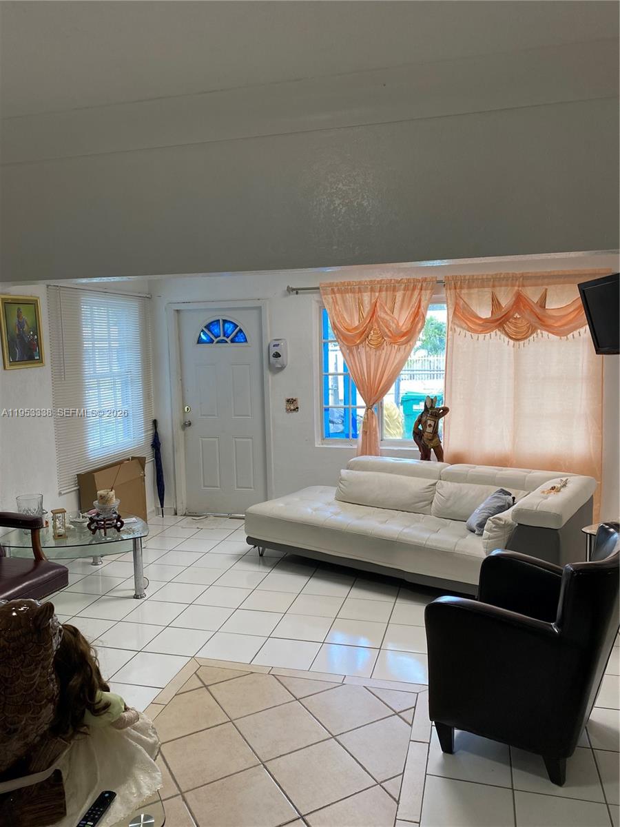1455 Northwest 112th Street Miami, FL 33167 - Photo 6 of 19 a living room with furniture and a window