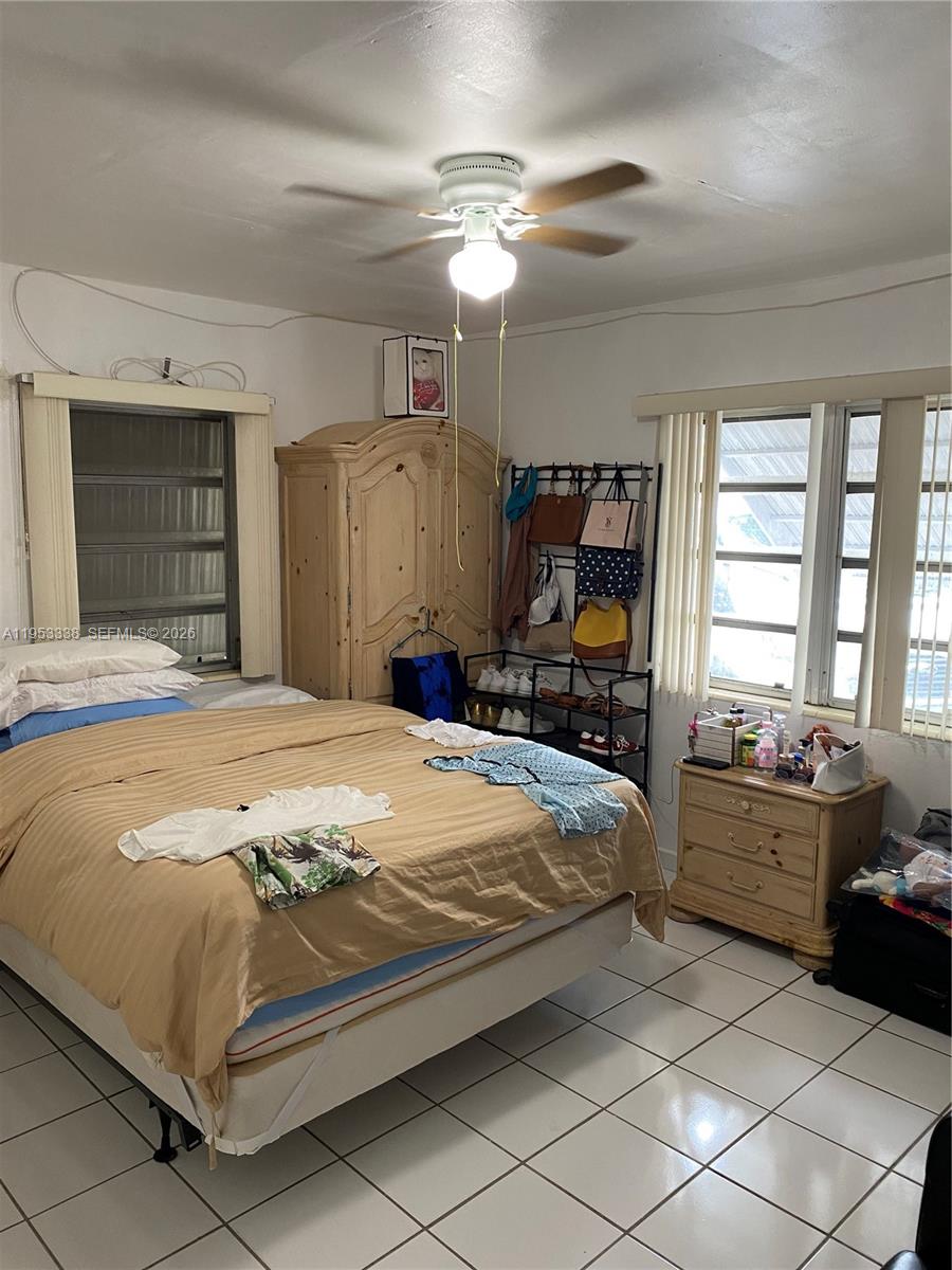 1455 Northwest 112th Street Miami, FL 33167 - Photo 9 of 19 a bedroom with a bed and a large mirror