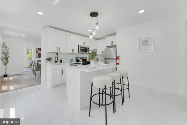 a kitchen with stainless steel appliances kitchen island granite countertop a sink and cabinets