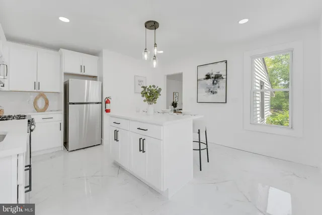 a kitchen with stainless steel appliances a refrigerator sink and cabinets
