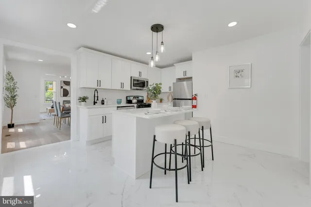 a kitchen with stainless steel appliances kitchen island granite countertop a sink and cabinets