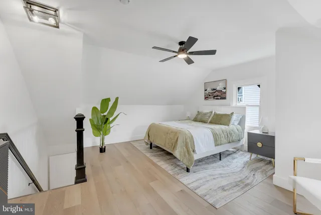 a bedroom with a bed table and a window