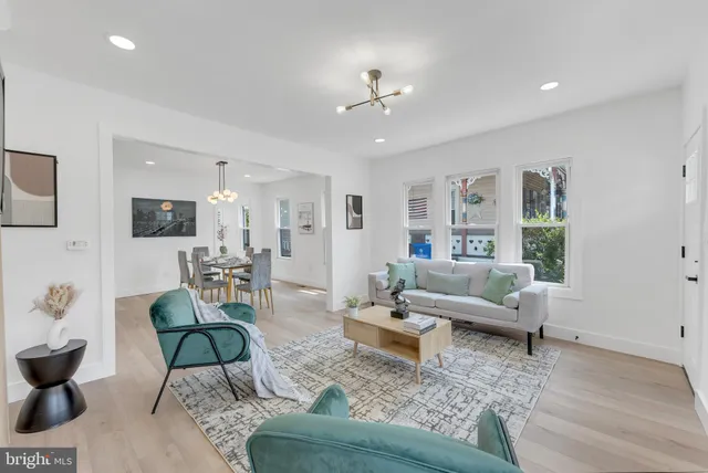 a living room with furniture and view of kitchen