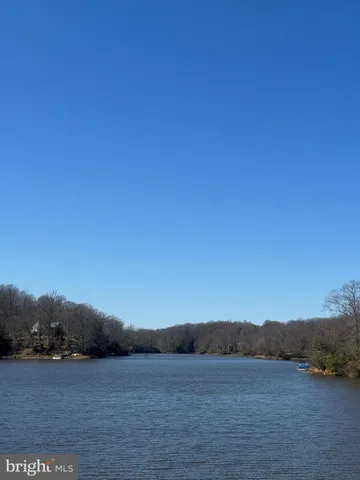 a view of a dry yard with wooden fence