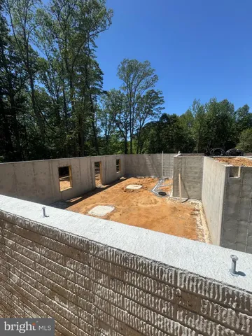 an aerial view of a house with garden space and ocean view