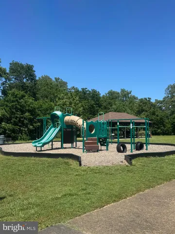 a view of a playground with a yard