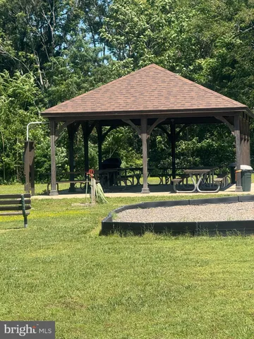 a backyard of a house with lots of green space and fountain