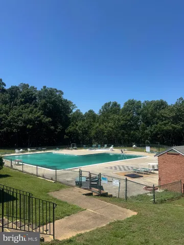 a view of a swimming pool with a table and chairs